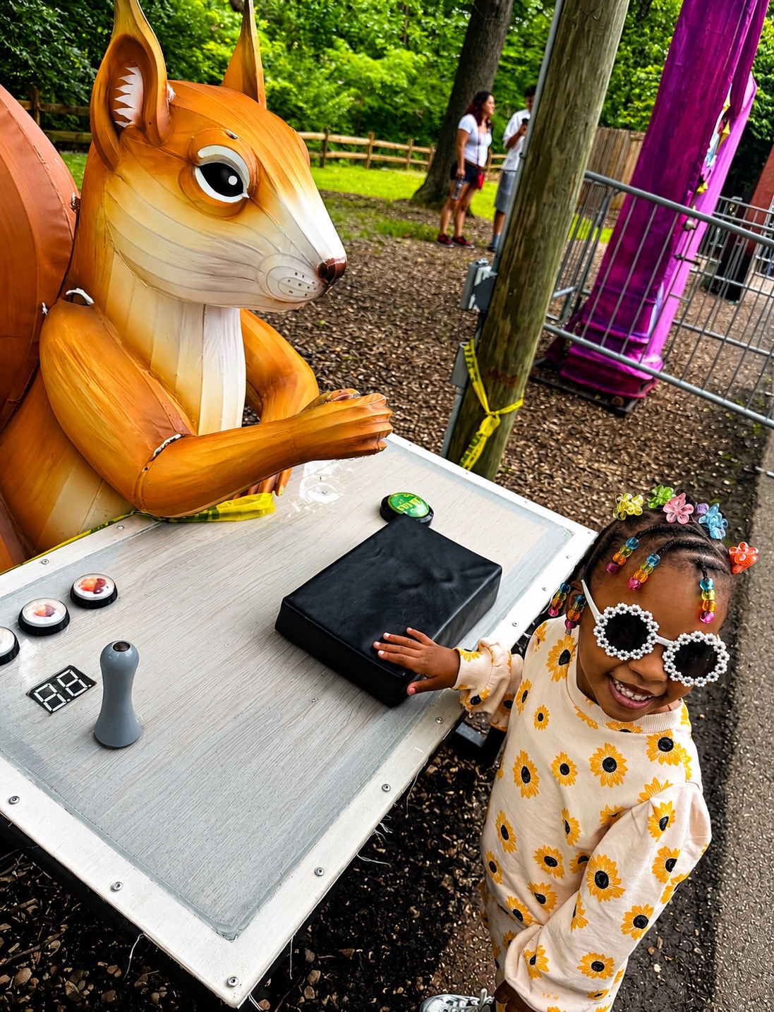 A smiling child enjoying an outdoor field trip exhibit