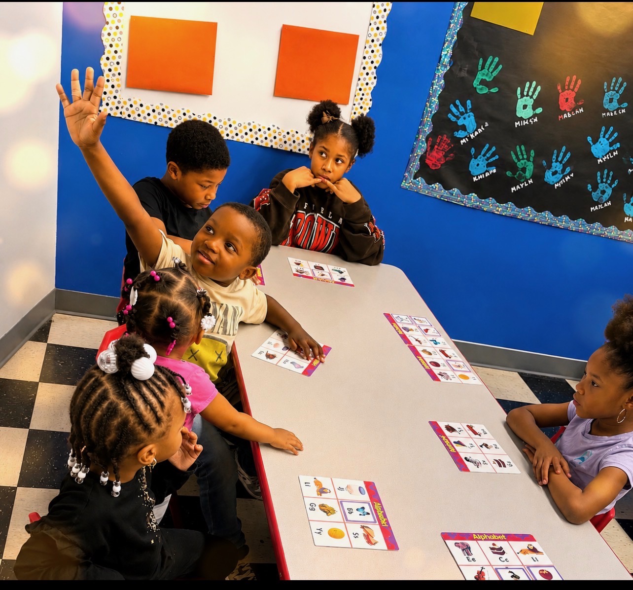 Children working together on alphabet activities at Discovering Minds